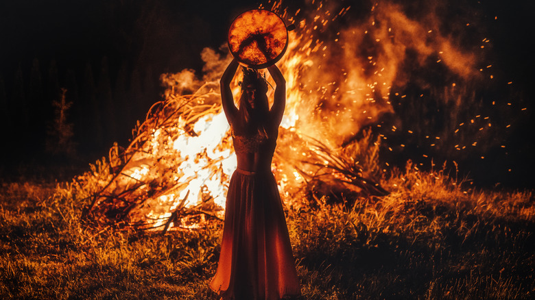 Woman in front of fire