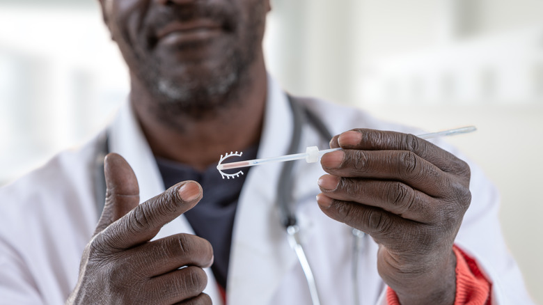 male gynecologist pointing at an IUD