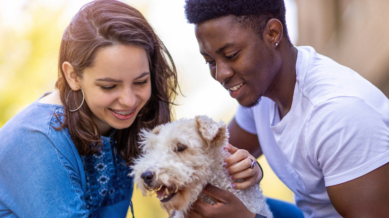 man and woman with dog