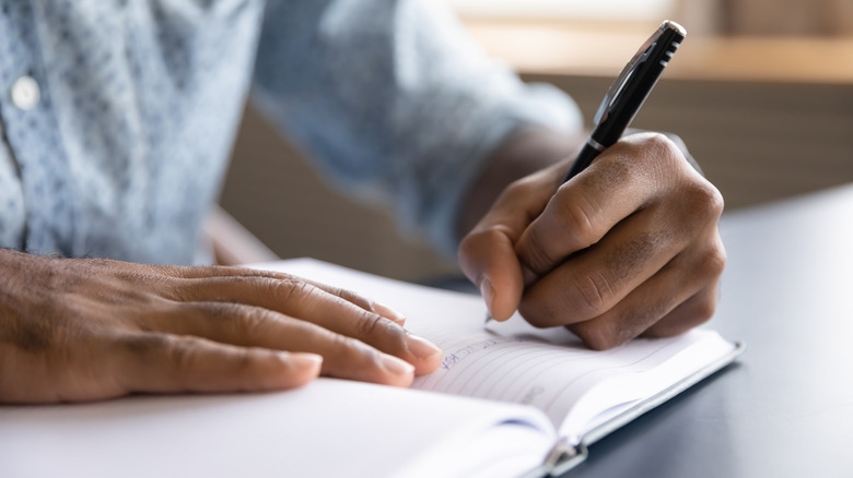 Person writing in notebook