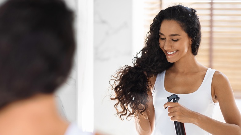 woman spraying hair with water