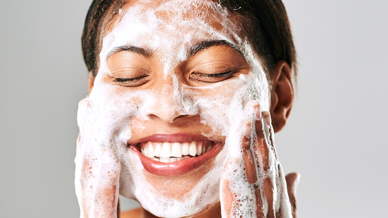 Woman applying a foaming cleanser