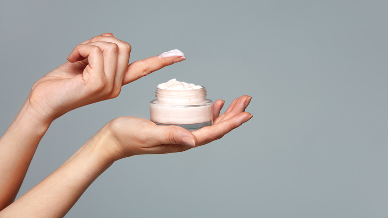 Woman holding skin cream