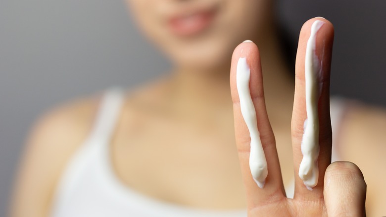 woman getting ready to apply sunscreen