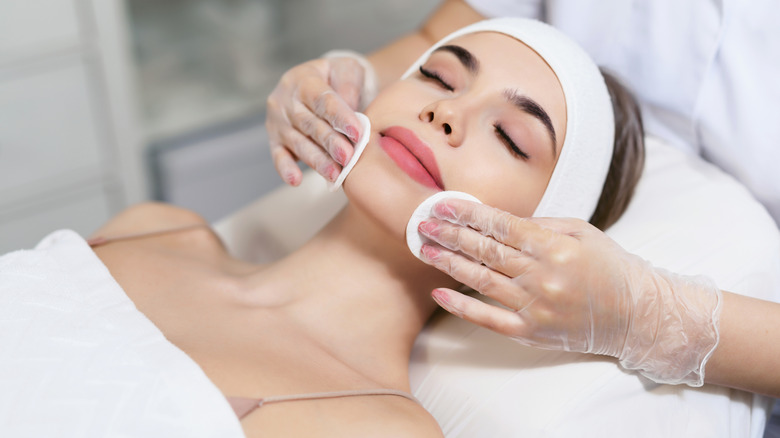 Woman receiving facial treatment 