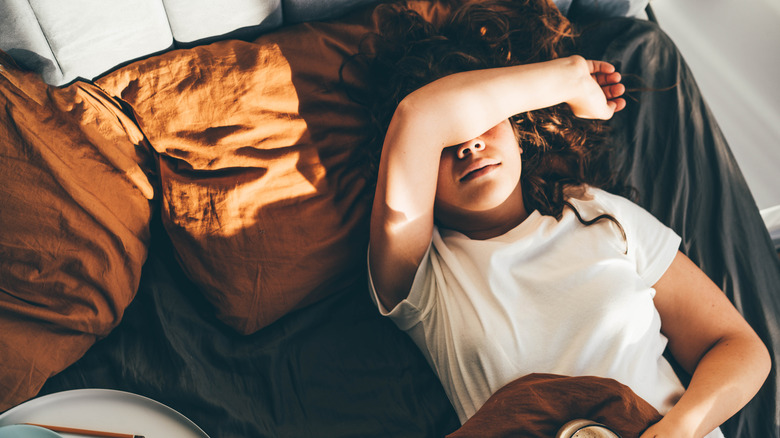 Woman in bed looking tired 