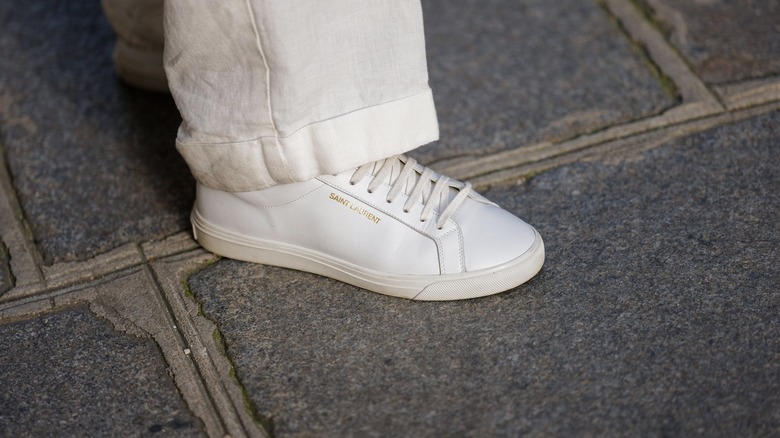 woman wearing white leather sneakers