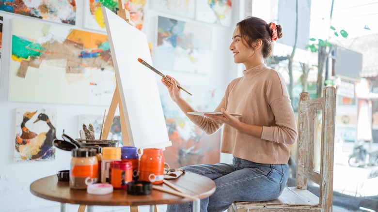 Woman painting in studio