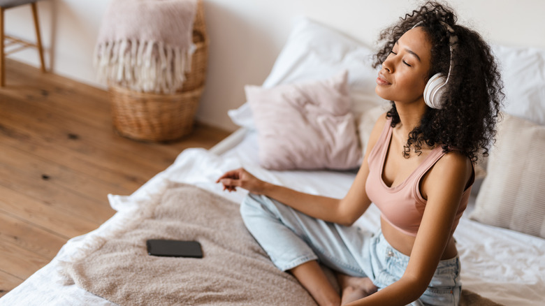 Woman meditating on bed