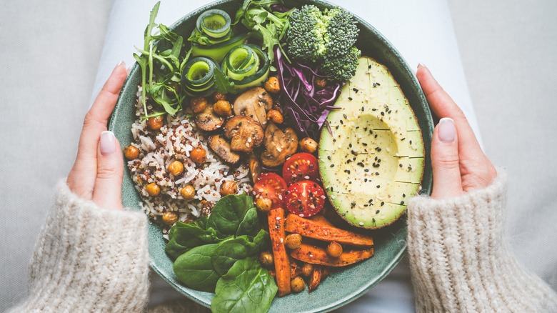 Holding bowl of vegetables