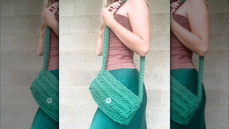 Woman models green crochet mini-messenger bag