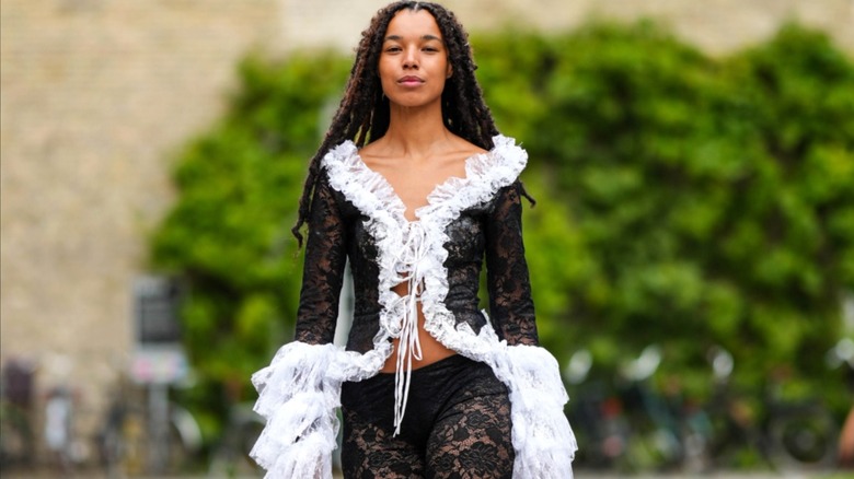 Woman wearing ruffled lace cardigan and skirt