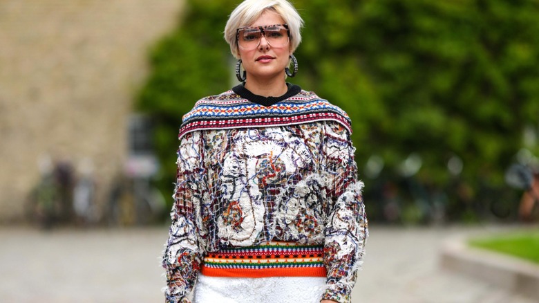 Woman wearing colorful patterned sweater