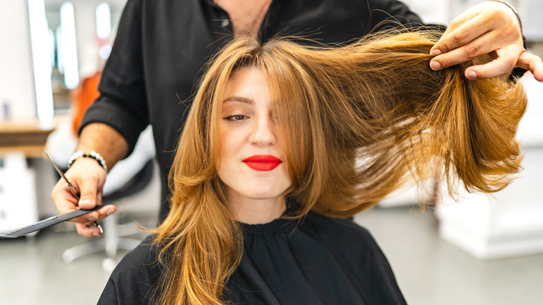 Woman getting layered haircut