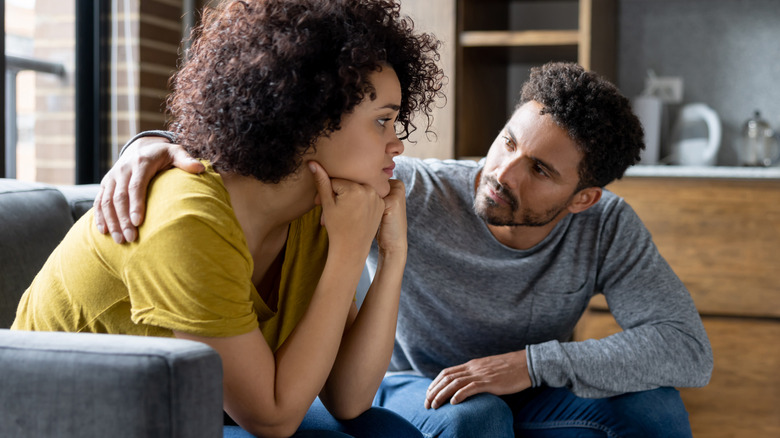 Man comforting worried woman