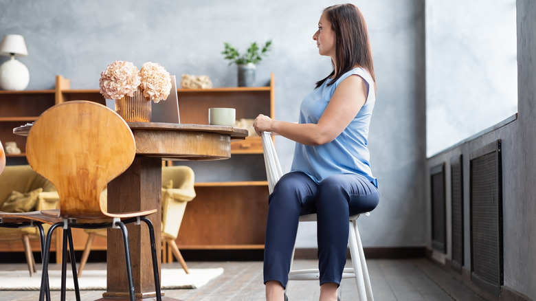 Woman doing spinal twist in chair