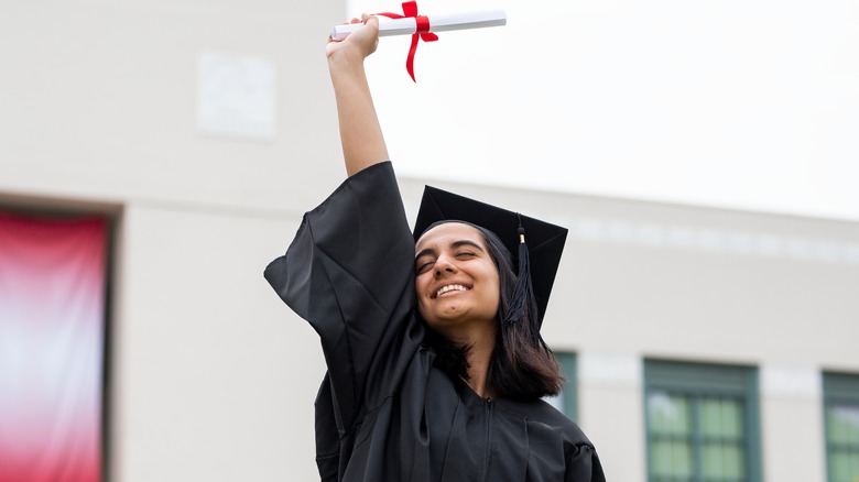 Woman holding college diploma