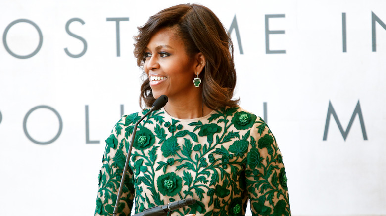 Michelle Obama wearing a green-flowers-embellished top