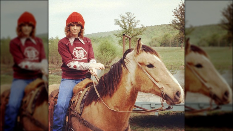 Reba riding a horse