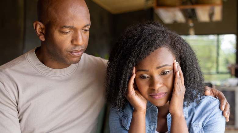 Man comforting sad woman