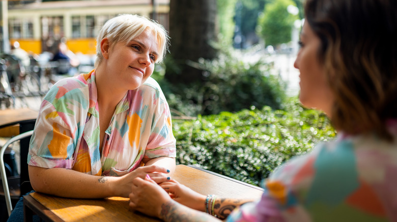 Smiling women talking at a café