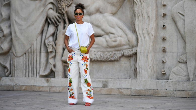 woman in white floral wide-leg pants