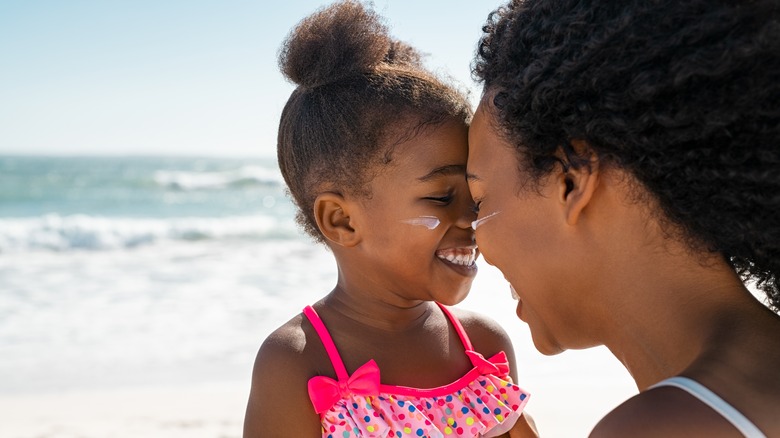 mother and daughter with sunscreen on