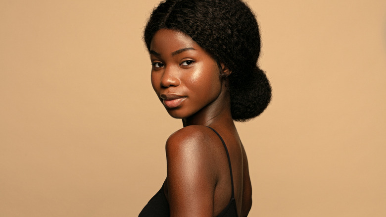 young dark skinned woman with glowing skin