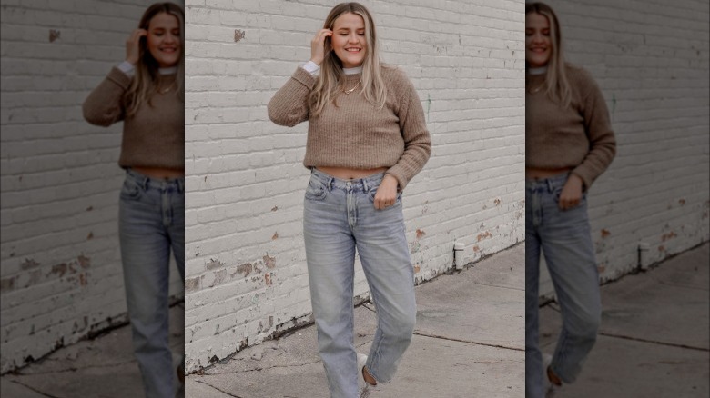 Woman wearing tucked sweater and jeans 