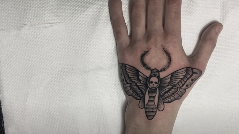 Moth tattoo design on hand