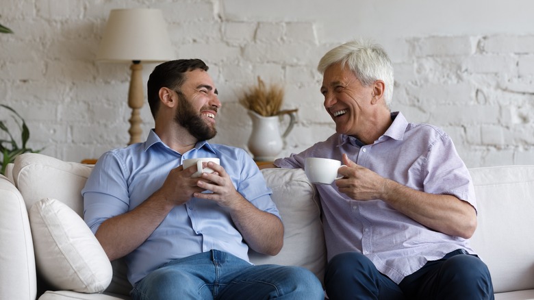 Two men sitting on couch 