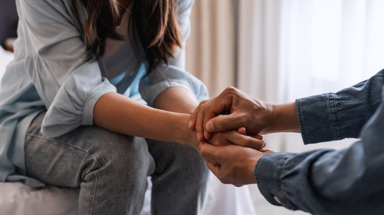 Couple holding hands while talking