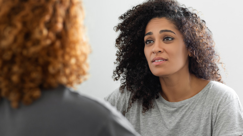 Two women talking intently