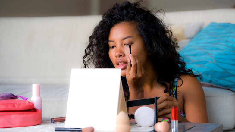 woman applying eyeshadow