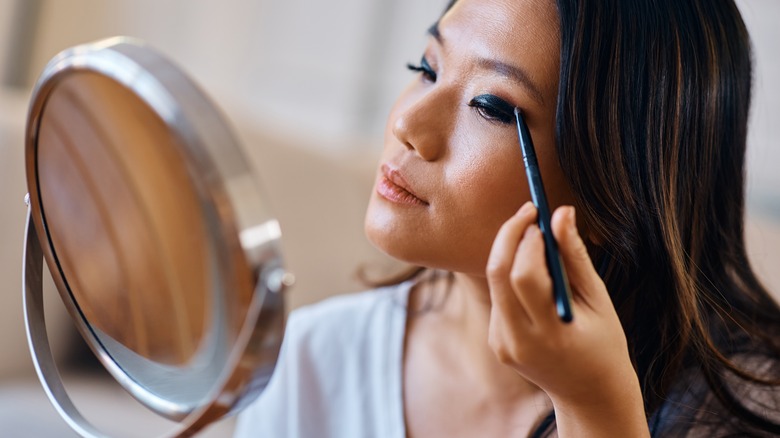 woman applying eyeshadow