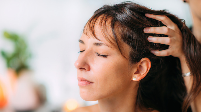 woman massaging scalp