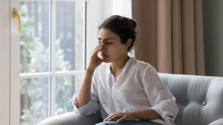 Sad woman sitting on sofa 