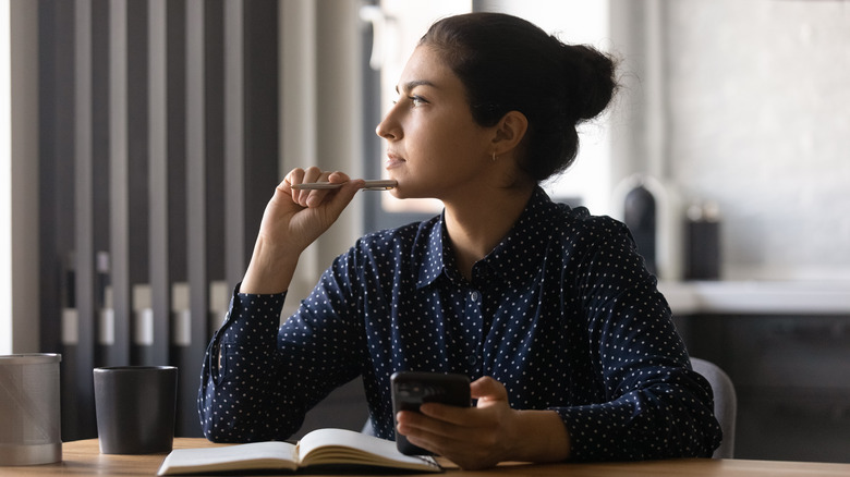 woman with notebook and phone