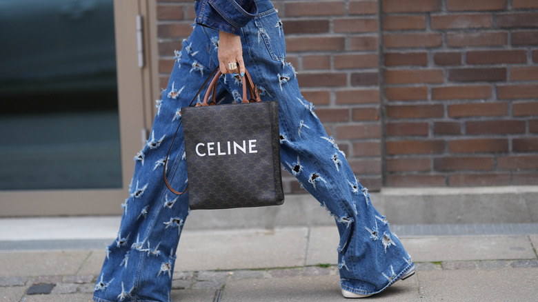 woman wearing cutout denim pants