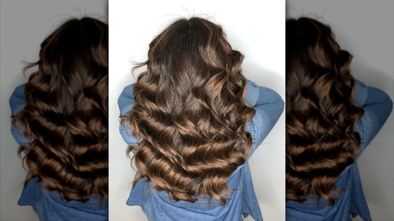 woman showcasing dyed hair with caramel highlights 