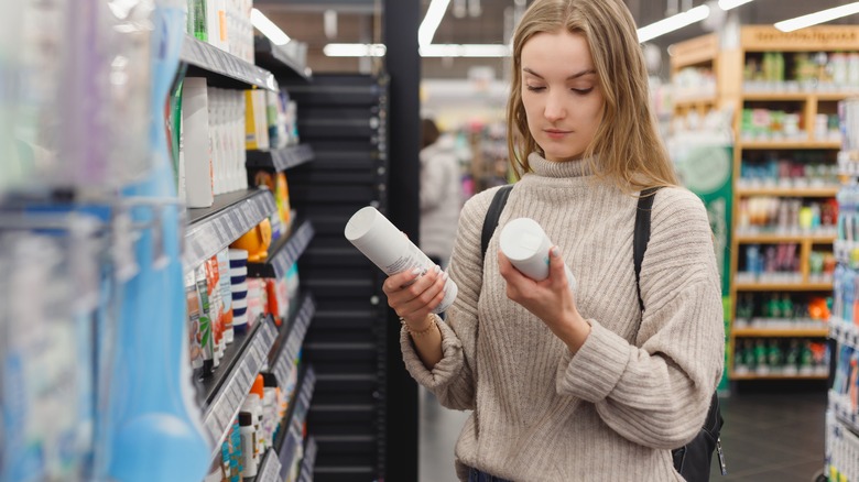 Woman picking shampoo