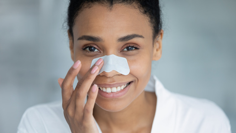 Smiling woman wearing nose strip 