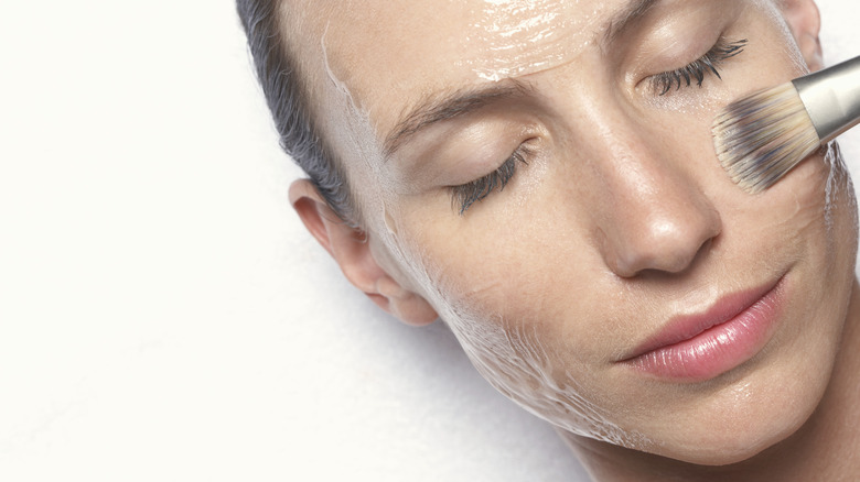 Woman applying a face mask 