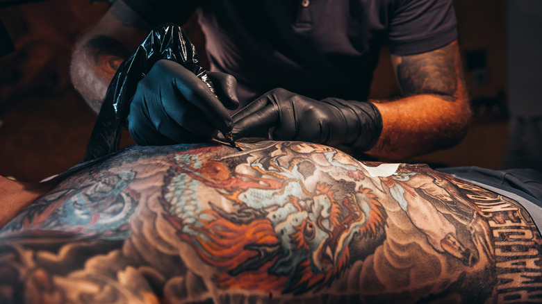 tattoo artist tattooing a person