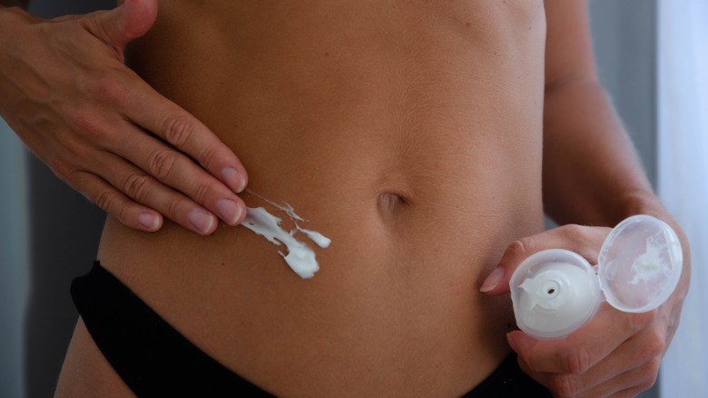 Woman applying sunscreen