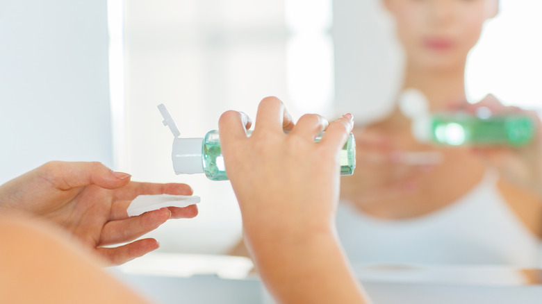 woman applying glycolic toner