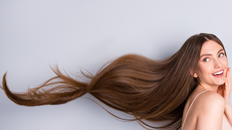 woman with flowing long hair poses