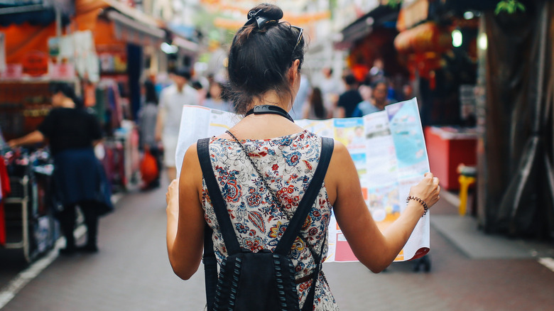 woman exploring with map