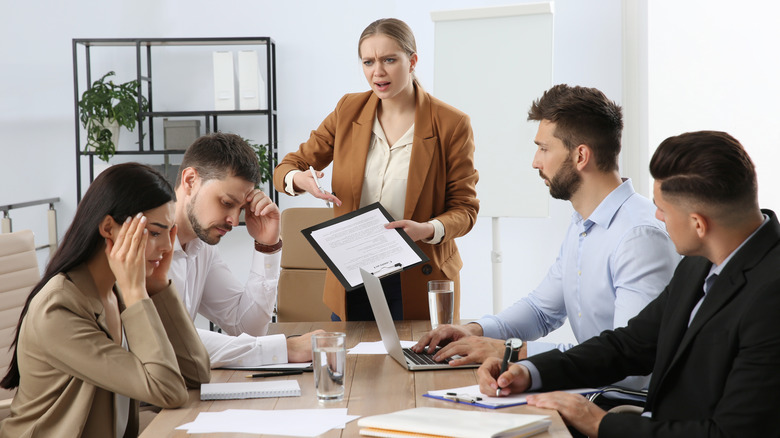 woman acting controlling in meeting