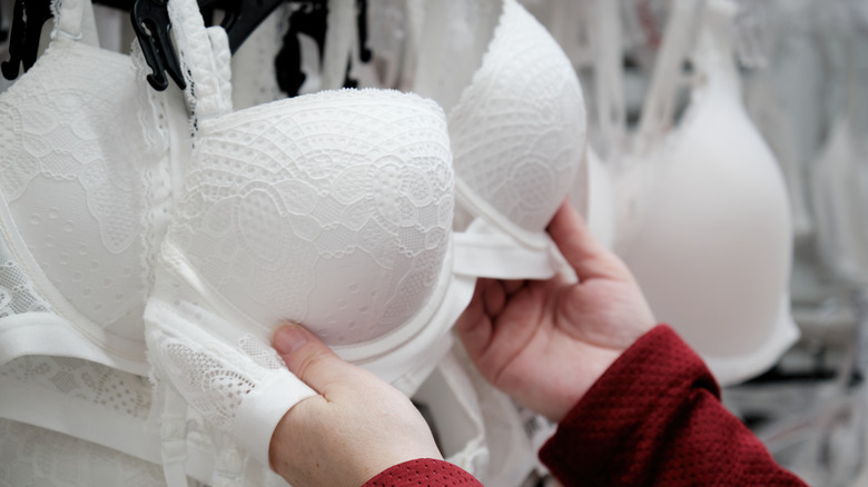 Woman inspecting a bra in a store